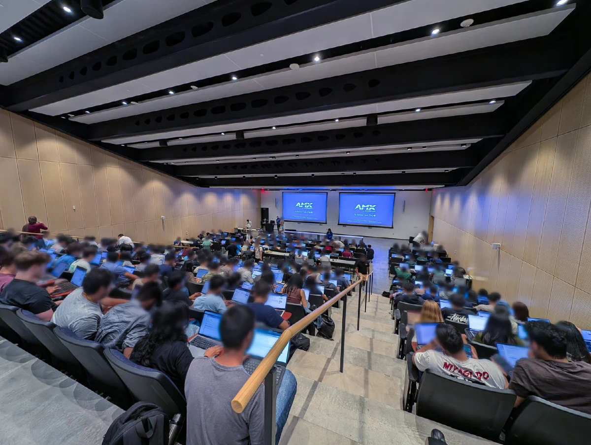 450-plus student flipped classroom teams working through database exercises while staff coach.